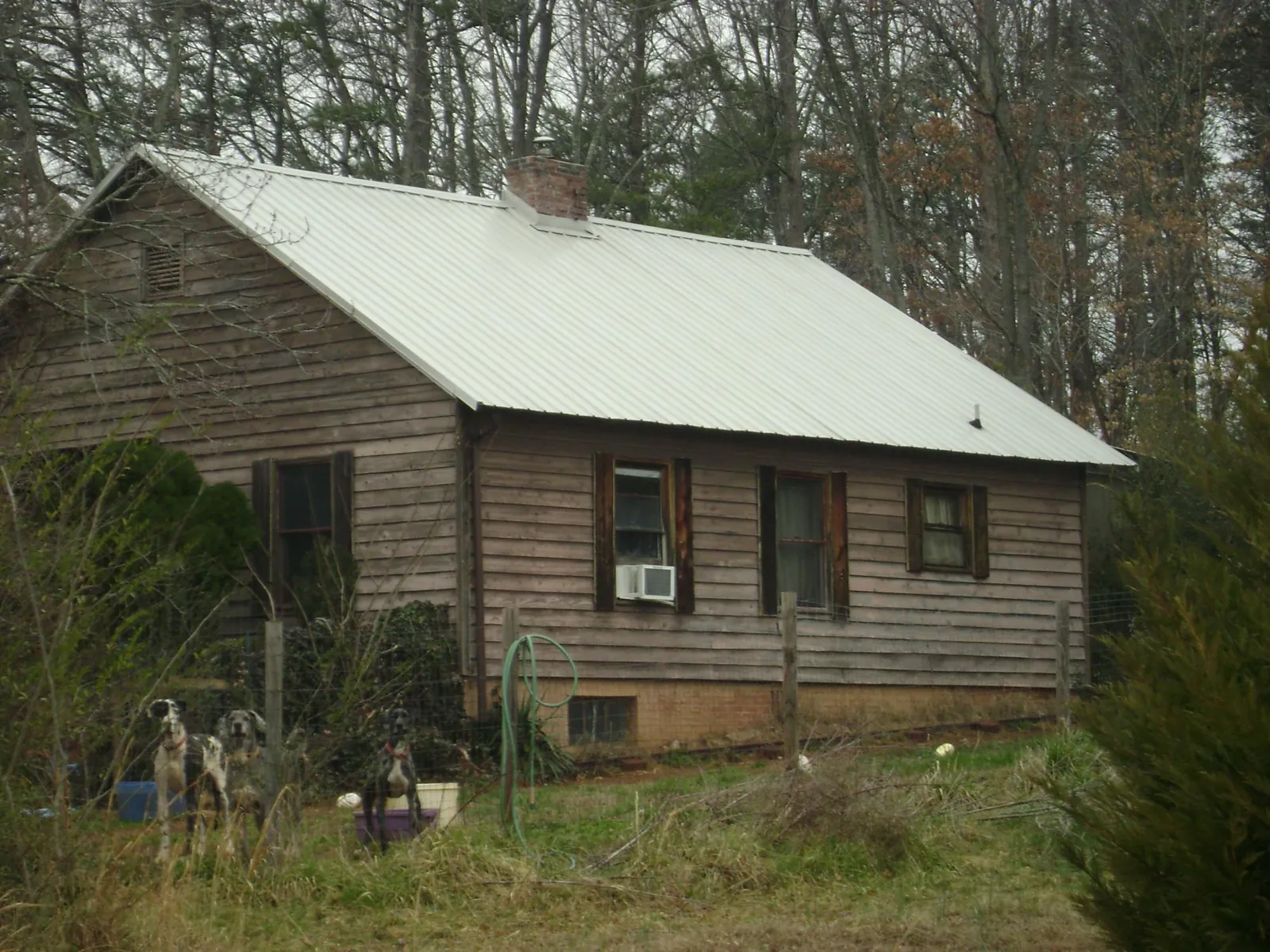White metal roof on an old wood sided farmhouse, from a Metal Roof Installation job in Peconic